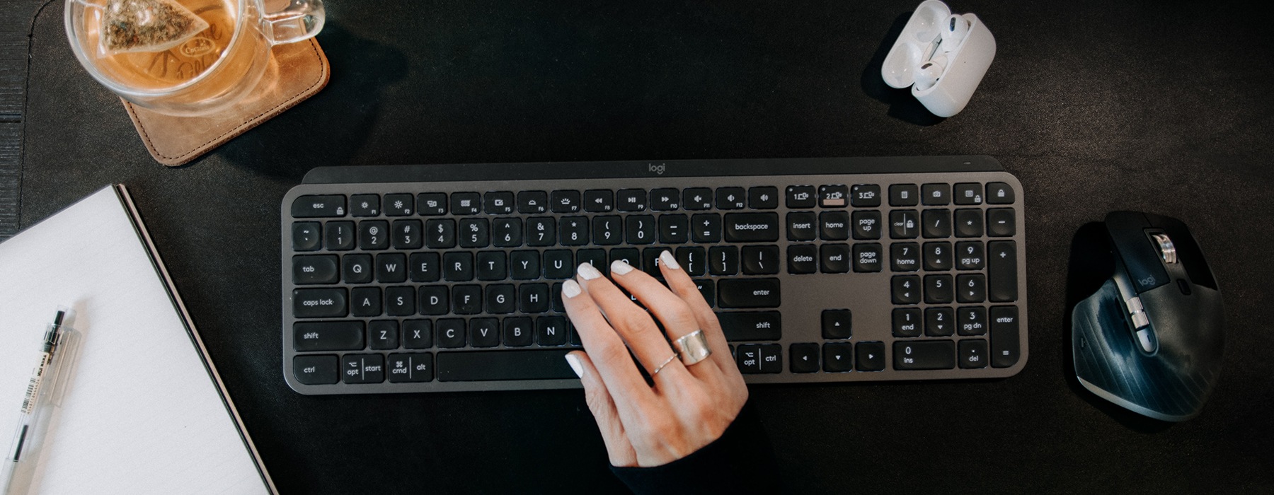 wide view of someone typing on a keyboard with modern decor nearby
